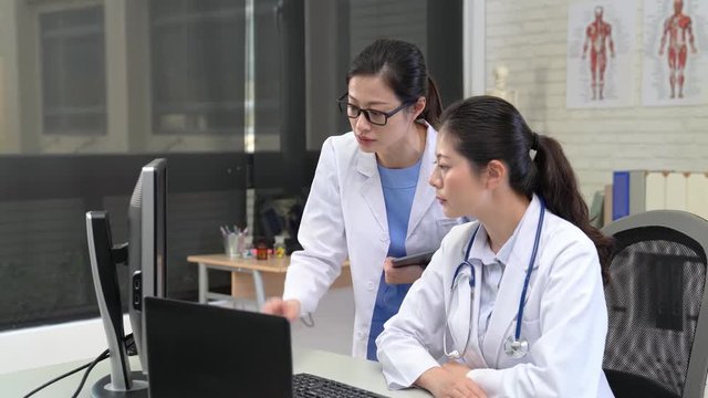 two doctors team looking at laptop