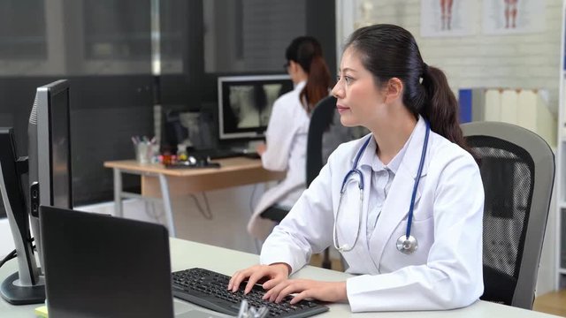 Asian woman Medical Looking Into Camera