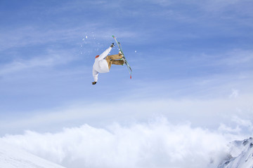 Skier jump in the mountains. Extreme ski sport. Freeride.