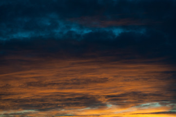Beautiful sky with colorful clouds. Blue and orange clouds. Abstract wallpaper, background.