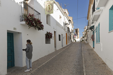 Teen with his camera of photos walking
