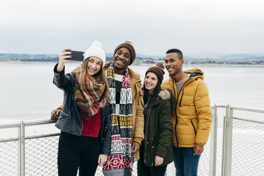 Friends taking selfie in harbor