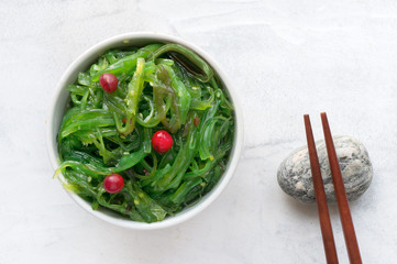 Wakame seaweed salad with sesame seed. Traditional Japanese food. Top view. 