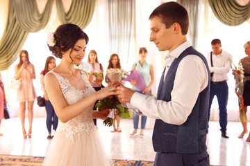 Wedding ceremony. The groom wears a ring to the bride