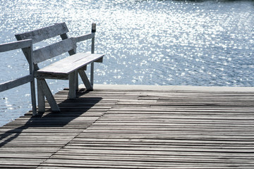 Fototapeta na wymiar Wooden chairs and pond for relax time at home