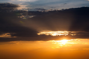 Sun rays through clouds like an dramatic explosion , power nature background.