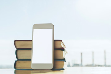 White smartphone and books
