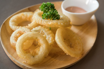 fried onion rings in batter with sauce