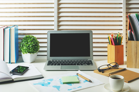 Designer desk top with empty laptop