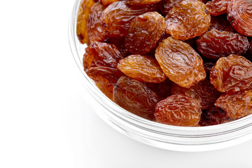 bowl of raisins on a white background. Dried grapes.