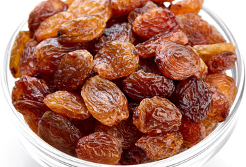 bowl of raisins on a white background. Dried grapes.
