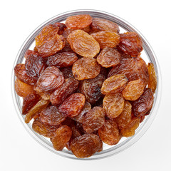 bowl of raisins on a white background. Dried grapes.