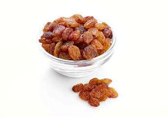 bowl of raisins on a white background. Dried grapes.