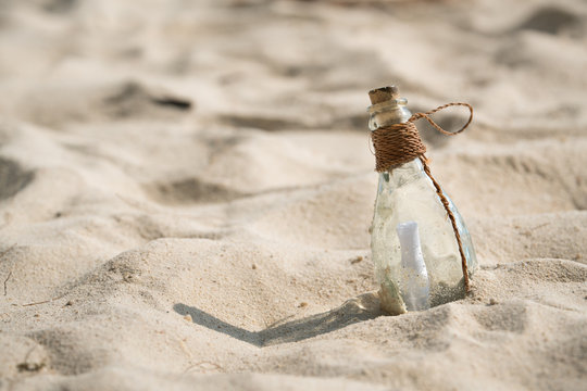 Letter message in a glass bottle on the beach , concept for communication.
