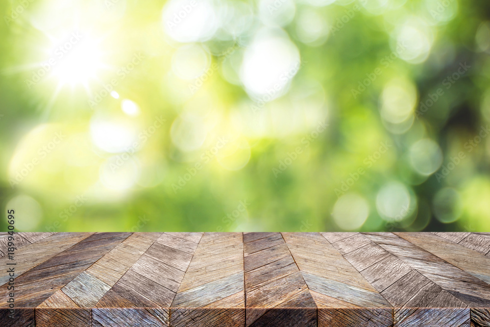 Aufkleber empty old grunge wood plank table top with blur green tree in park bokeh sunlight,mock up for displa