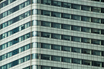 Fototapeta premium Glass facade of modern city high rise buildings