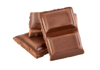 Milk chocolate pieces isolated on white background.