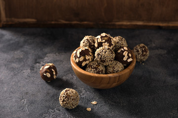 Vegan sweet bites, raw eating dessert with nuts and cacao, sesam and oats