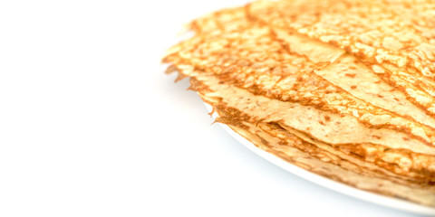 Close up on a stack of crepes (french pancakes) on a plate, white background