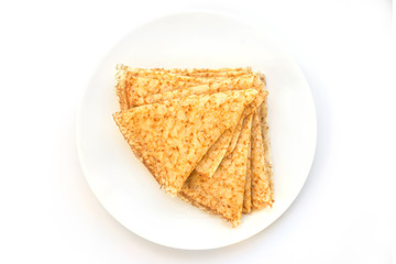 Close up on a stack of folded crepes (french pancakes) on a plate, white background