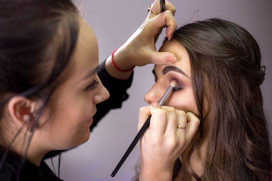Make-up artist makes make-up an attractive model