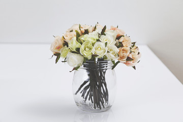 Bouquet of flowers in a vase placed on a table. 