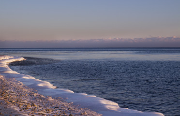 eautiful winter sunset on the coast of Lake Baikal. Siberia