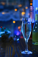 A glass of Sparkling wine in front of defocused colorful lights of blue tone background, cool tone and romantic mood 1