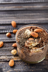 chia pudding with chocolate banana smoothie in a glass jar on the old wooden background