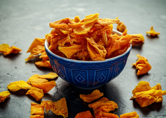 Tasty organic dried mango chips in bowl. healthy food