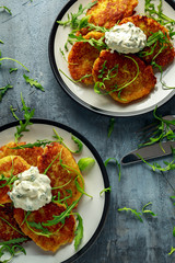 Potato pancakes, draniki, hash browns or fritters served with... fresh wild rocket leaves salad.