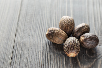 Nutmeg, on a wooden background, close-up