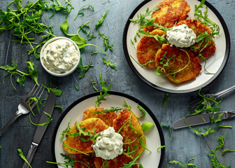 Potato pancakes, draniki, hash browns or fritters served with... fresh wild rocket leaves salad.