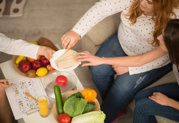 Close up image of patient and dietitian. Fruit and vegetables on table.