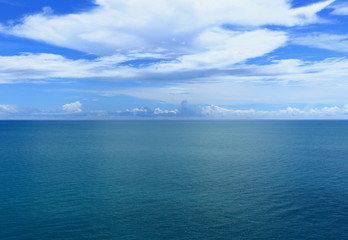 Perfect landscape with turquoise water of the South China Sea with shallow ripples on the surface under amazing white clouds.