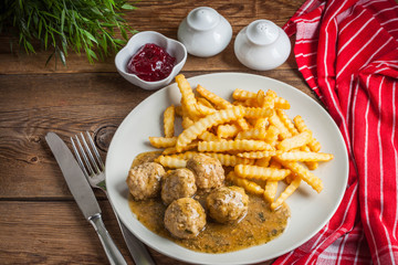 Meatballs with french fries in dill sauce.