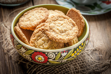 Stack of freshly baked oat biscuits in a bowl.