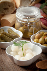 Tapas with sliced sausage, salami, olives and parsley.