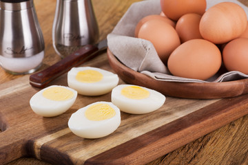 Sliced Hard Boiled Eggs with a Bowl of Brown Eggs