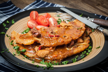 Potato pancakes with meat, vegetable, tomato and parsley.