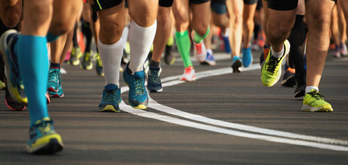 Marathon running race people feet on city road