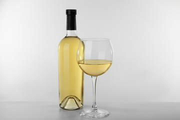 Bottle of wine and glass on white background