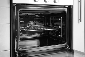 Selbstklebende Fototapeten Empty electric oven in kitchen, closeup © Africa Studio