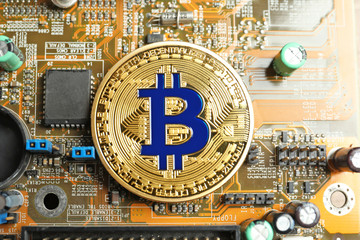 Golden bitcoin on PC motherboard