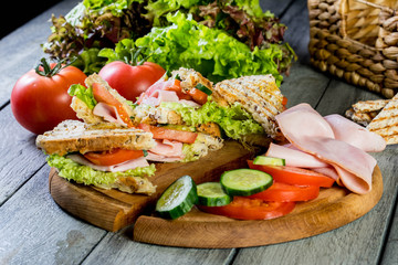 Panini sandwich with ham, tomato and lettuce.