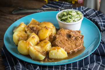 Braised meat in sauce served with boiled potatoes.