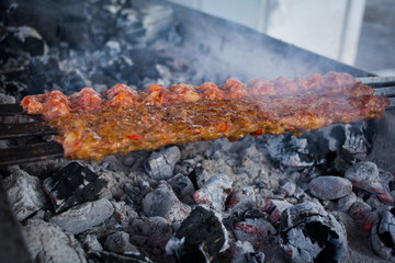cooking adana kebabs on bbq grill