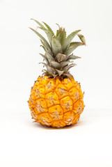 ripe tasty baby pineapple on white background