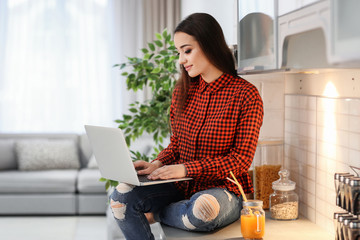 Young woman using laptop indoors