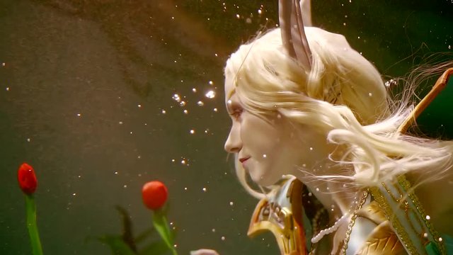 mysterious elf girl with long white hair floats under water